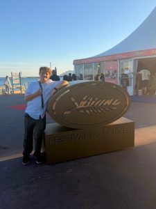 Student Cory Ray by the “Festival De Cannes” sign. Photo Credits: Cory Ray