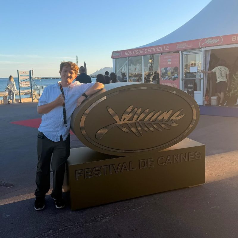 Student Cory Ray by the “Festival De Cannes” sign. Photo Credits: Cory Ray
